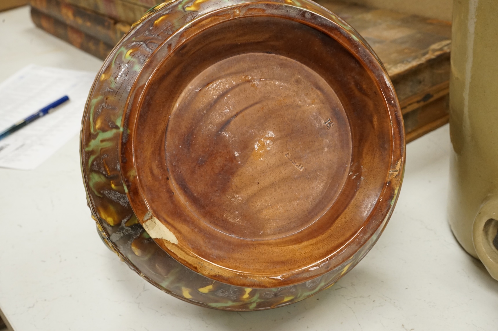 A German earthenware flagon, 32cm tall, together with a Beard & Co of Lewes stoneware liqueur flask